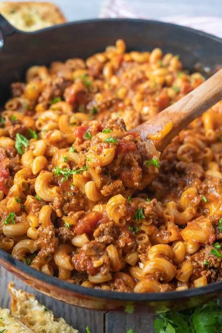 The Ultimate Old-Fashioned American Goulash (One-Pot Comfort Food) An overhead close-up shot of old-fashioned American Goulash with ground beef and elbow macaroni in a cast-iron skillet.