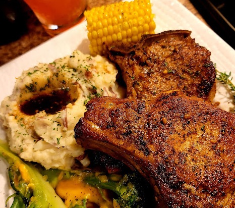 The Ultimate Juicy Garlic Soy Marinated Pork Chops Juicy pan-seared pork chops marinated in a savory garlic soy and lemon sauce, served with mashed potatoes and corn on the cob.