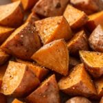 Easy crispy air fryer sweet potato cubes seasoned with garlic powder and smoked paprika.